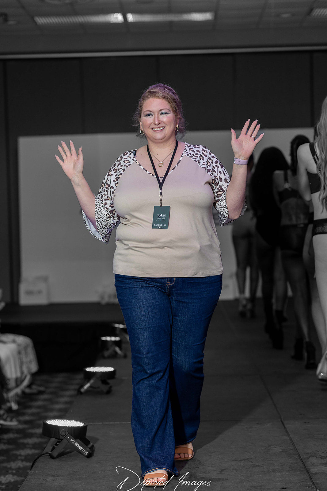 Photo of La Plantureuse's Founder Amanda on the Acadiana Fashion Week Runway waving at the crowd and being confident and radiate